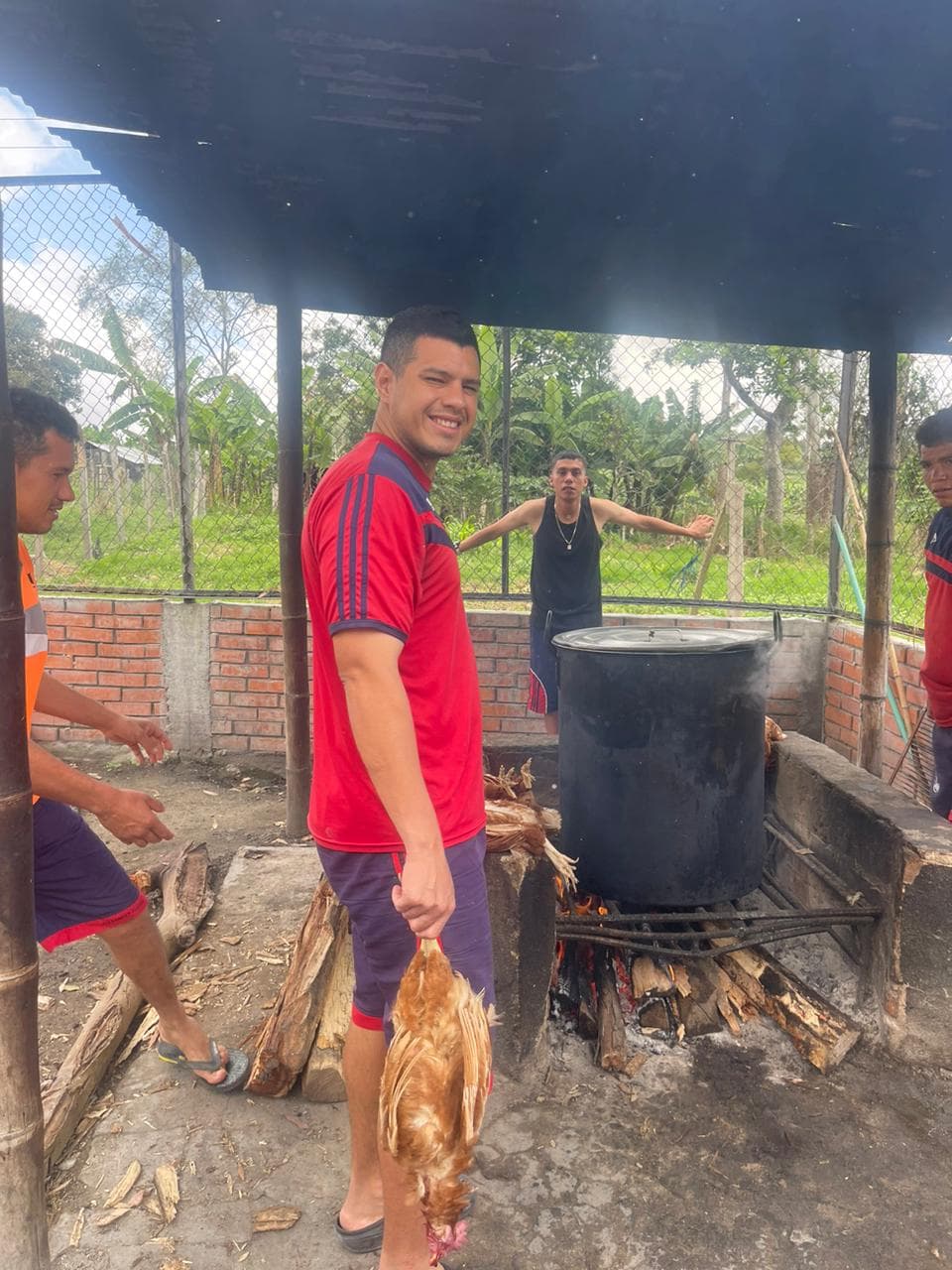 Wood-fire cooking station with a large pot during food preparation