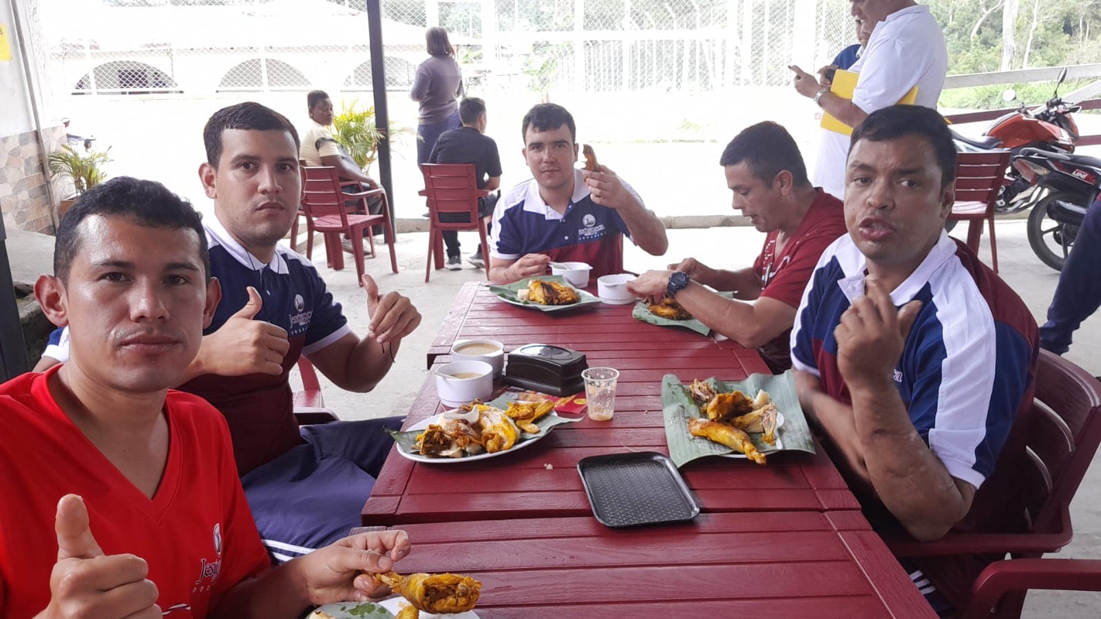 Communal table with plates of food served on leaves